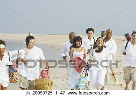 Friends walking on the beach together View Large Photo Image Stock Photo - Friends walking on the beach together. Fotosearch