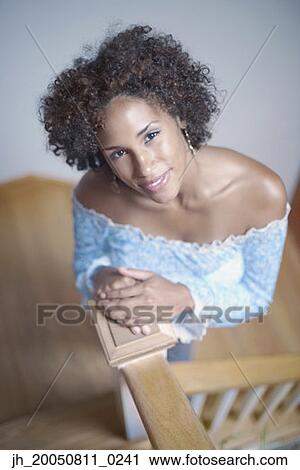 High angle view of young woman smiling for the camera View Large Photo Image Stock Image - High angle view of young woman smiling for the camera. Fotosearch