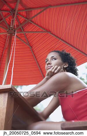 Low angle portrait of young woman View Large Photo Image Picture - Low angle portrait of young woman. Fotosearch