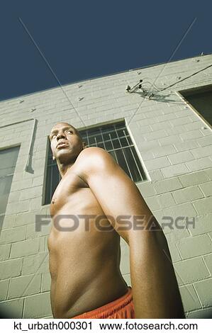 Low angle view of young male athlete's body View Large Photo Image Stock Image - Low angle view of young male athlete's body. Fotosearch