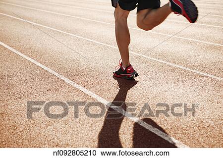 Male athlete running on a track View Large Photo Image Stock Image - Male athlete running on a track. Fotosearch