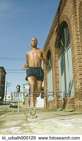 Male jogger running in urban surroundings View Large Photo Image Stock Photo - Male jogger running in urban surroundings. Fotosearch