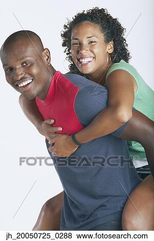 Man carrying his girlfriend on his back View Large Photo Image Stock Photo - Man carrying his girlfriend on his back. Fotosearch