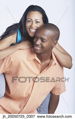 Man carrying his girlfriend on his back View Large Photo Image Stock Photo - Man carrying his girlfriend on his back. Fotosearch