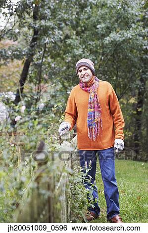 Stock Photograph - Man gardening outdoors. Fotosearch
