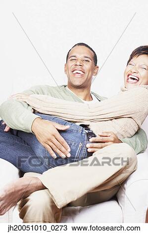 Man holding his girlfriend on his lap View Large Photo Image Stock Image - Man holding his girlfriend on his lap. Fotosearch