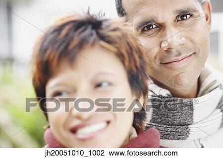 Man smiling for the camera beside his girlfriend View Large Photo Image Stock Image - Man smiling for the camera beside his girlfriend. Fotosearch