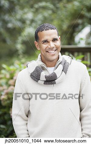 Man smiling for the camera outdoors View Large Photo Image Picture - Man smiling for the camera outdoors. Fotosearch