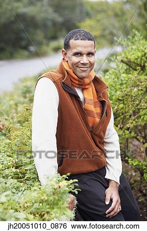 Man smiling for the camera outdoors View Large Photo Image Stock Photograph - Man smiling for the camera outdoors. Fotosearch
