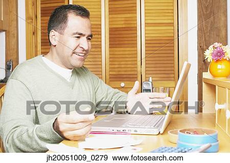 Man using a laptop View Large Photo Image Stock Photo - Man using a laptop. Fotosearch