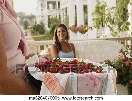 Mature woman holding basket of strawberries View Large Photo Image Stock Photography - Mature woman holding basket of strawberries. Fotosearch