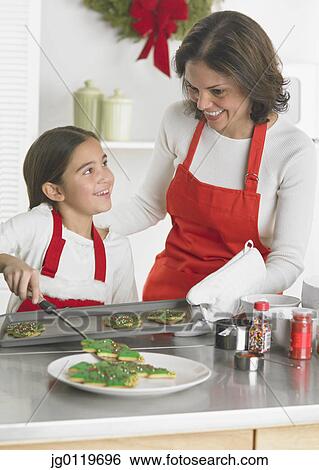 Mother and daughter baking together View Large Photo Image Stock Photograph - Mother and daughter baking together. Fotosearch