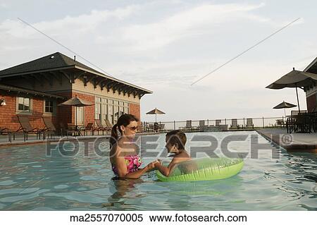 Stock Photography - Mother and son playing in a swimming pool. Fotosearch