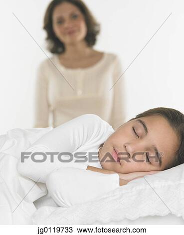 Mother watching her daughter sleep View Large Photo Image Stock Image - Mother watching her daughter sleep. Fotosearch