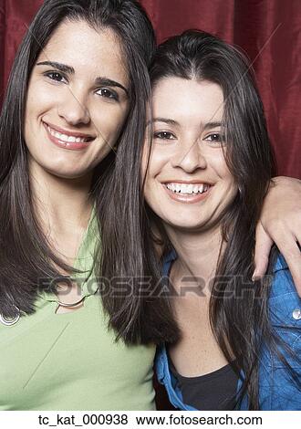 Sisters smiling for the camera View Large Photo Image Stock Photo - Sisters smiling for the camera. Fotosearch