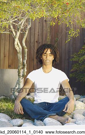 Teenage boy meditating outdoors View Large Photo Image Stock Image - Teenage boy meditating outdoors. Fotosearch