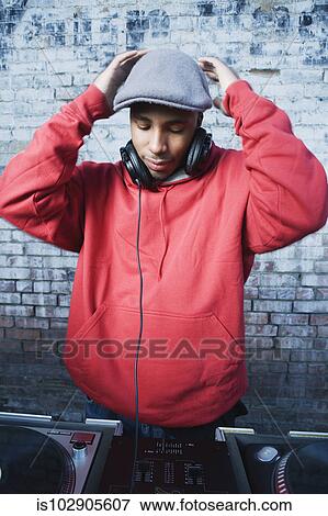 Teenage boy using turntables and headphones View Large Photo Image Stock Photo - Teenage boy using turntables and headphones. Fotosearch