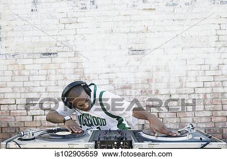 Teenage boy using turntables and headphones View Large Photo Image Stock Photo - Teenage boy using turntables and headphones. Fotosearch