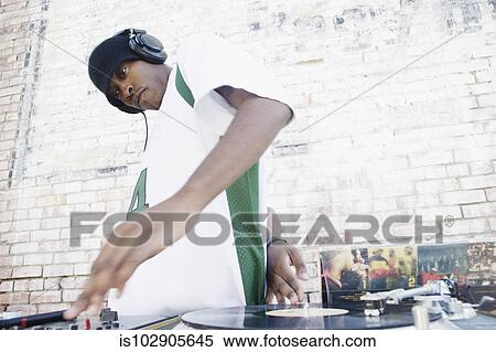 Teenage boy using turntables and headphones View Large Photo Image Stock Photography - Teenage boy using turntables and headphones. Fotosearch