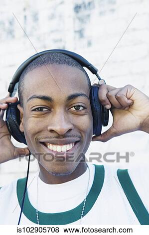 Stock Photo - Teenage boy wearing headphones. Fotosearch