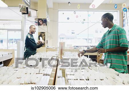 Teenage boys browsing in a music store View Large Photo Image Stock Photograph - Teenage boys browsing in a music store. Fotosearch