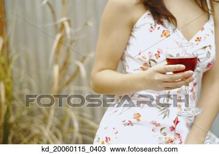 Woman holding a glass of wine View Large Photo Image Stock Image - Woman holding a glass of wine. Fotosearch