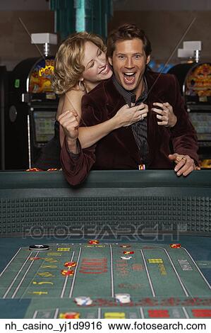 Woman hugging her successful boyfriend at a casino View Large Photo Image Stock Photograph - Woman hugging her successful boyfriend at a casino. Fotosearch