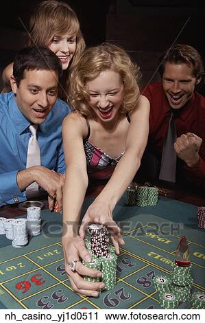 Stock Image - Woman successfully gambling in a casino. Fotosearch
