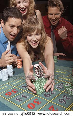 Stock Image - Woman successfully gambling in a casino. Fotosearch