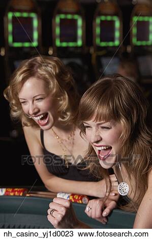Stock Image - Women gambling at a casino. Fotosearch