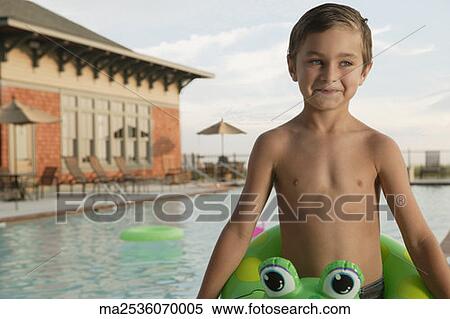 Stock Photography - Young boy in an inner tube smiling for the camera. Fotosearch