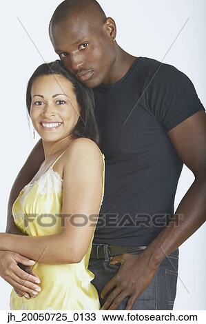 Young couple hugging and smiling for the camera View Large Photo Image Stock Image - Young couple hugging and smiling for the camera. Fotosearch