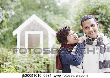 Stock Image - Young couple hugging outdoors. Fotosearch