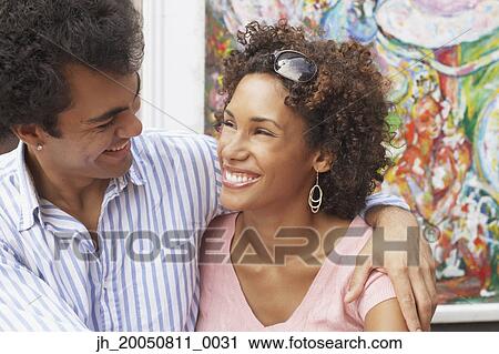 Young couple laughing View Large Photo Image Stock Image - Young couple laughing. Fotosearch