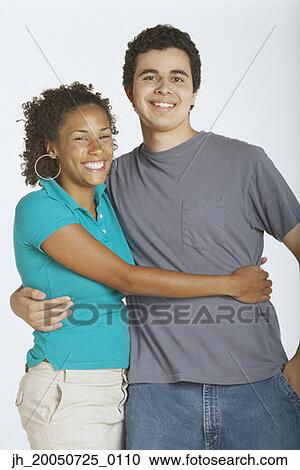 Young couple smiling for the camera View Large Photo Image Stock Image - Young couple smiling for the camera. Fotosearch