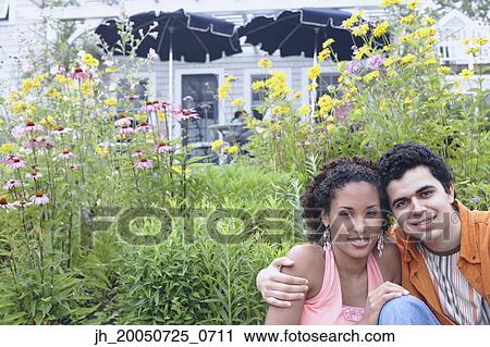 Stock Image - Young couple smiling for the camera. Fotosearch