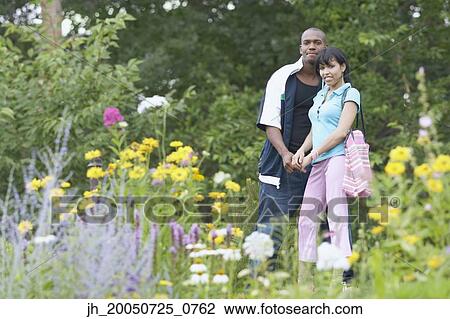 Young couple smiling for the camera View Large Photo Image Stock Image - Young couple smiling for the camera. Fotosearch