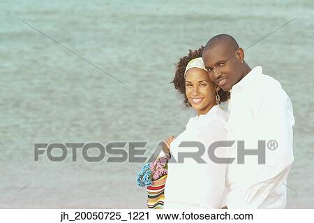 Young couple smiling for the camera View Large Photo Image Stock Image - Young couple smiling for the camera. Fotosearch