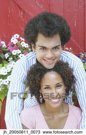 Young couple smiling for the camera View Large Photo Image Stock Image - Young couple smiling for the camera. Fotosearch