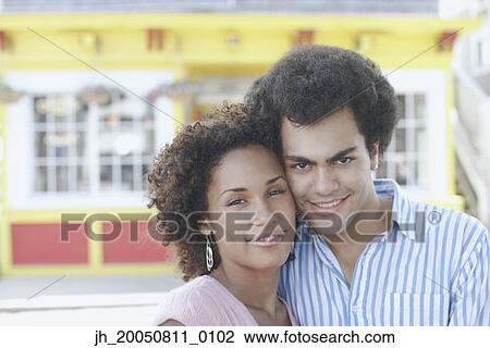 Young couple smiling for the camera View Large Photo Image Stock Image - Young couple smiling for the camera. Fotosearch