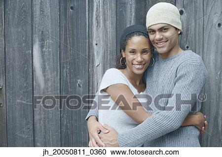 Young couple smiling for the camera View Large Photo Image Stock Image - Young couple smiling for the camera. Fotosearch