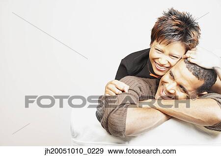 Young couple smiling for the camera View Large Photo Image Stock Photo - Young couple smiling for the camera. Fotosearch
