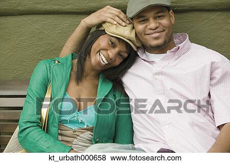 Young couple smiling for the camera View Large Photo Image Stock Photo - Young couple smiling for the camera. Fotosearch