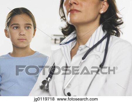 Stock Photo - Young girl admiring a female doctor. Fotosearch