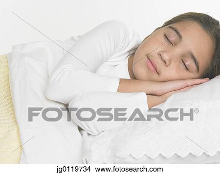 Picture - Young girl asleep in bed. Fotosearch