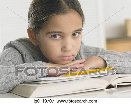 Stock Photo - Young girl doing her homework. Fotosearch