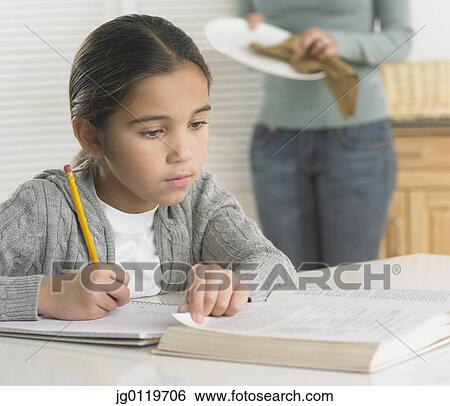 Stock Photograph - Young girl doing her homework. Fotosearch