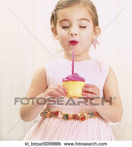 Young girl holding a birthday cupcake View Large Photo Image Stock Image - Young girl holding a birthday cupcake. Fotosearch