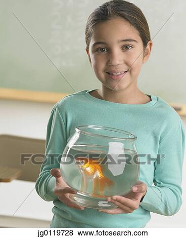 Young girl holding a fishbowl View Large Photo Image Stock Photo - Young girl holding a fishbowl. Fotosearch