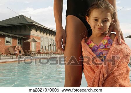 Young girl wrapped in a towel by swimming pool View Large Photo Image Stock Photography - Young girl wrapped in a towel by swimming pool. Fotosearch